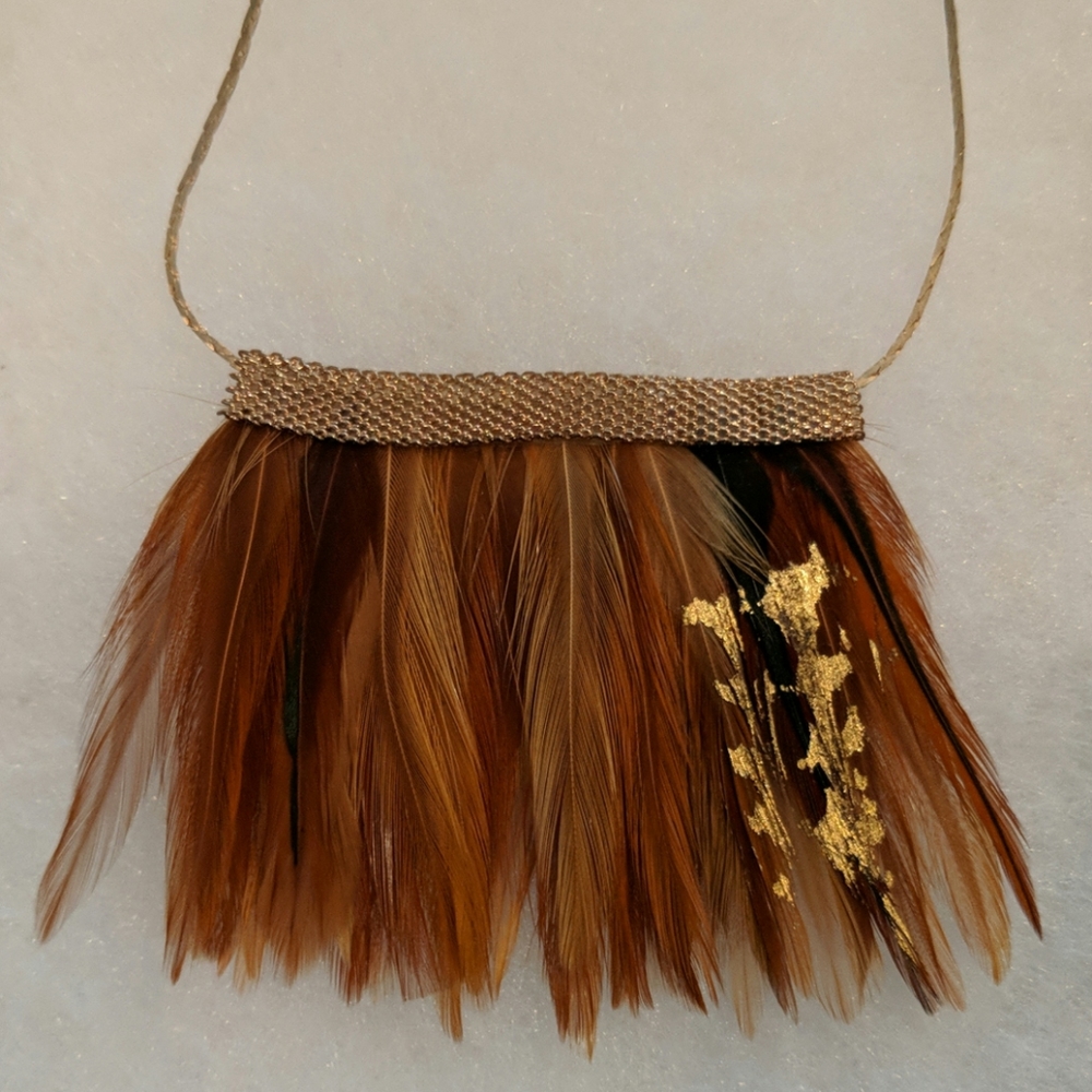 Gorgeous feather necklace on gold tone chain
